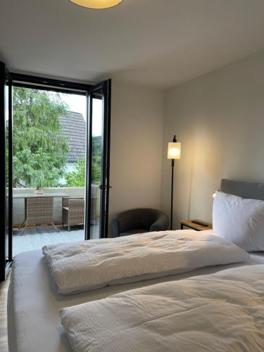 a bedroom with a large bed and a sliding glass door at Stadtvilla mit Pool in Jestetten