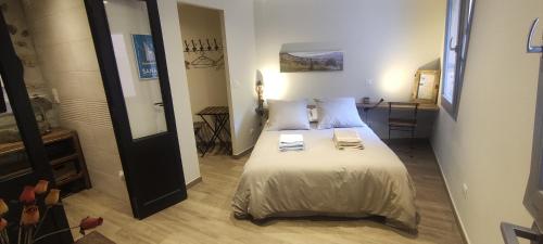 a bedroom with a bed with two books on it at Le Rouveau in Six-Fours-les-Plages