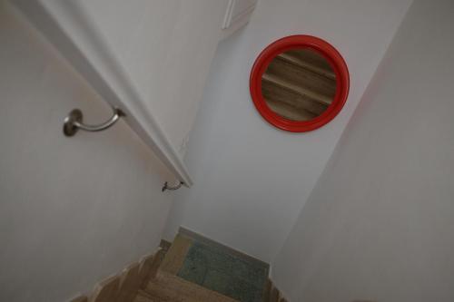a bathroom with a red mirror on the wall at Casa Margherita - Guest House in Pezze di Greco