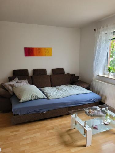 a bedroom with a bed and a glass table at Ferienwohnung Sonnenschein in Obernkirchen
