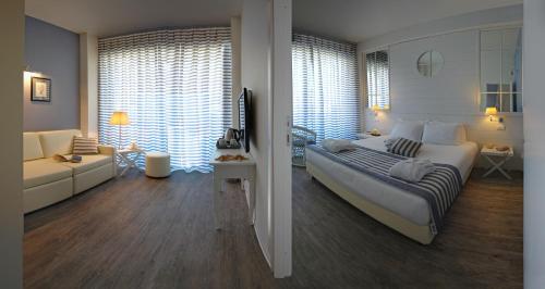 a bedroom with a large bed and a living room at Hotel Panorama in Cattolica