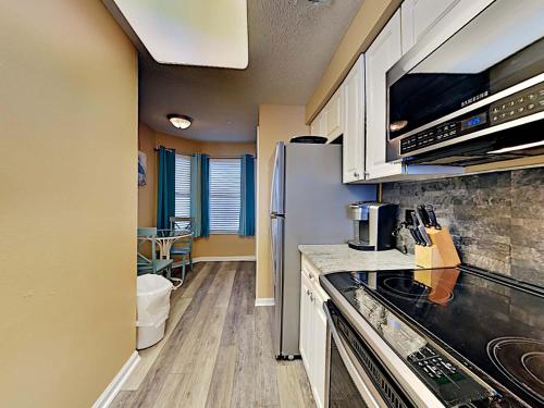 a kitchen with a refrigerator and a stove top oven at The Pearl of Navarre #1403 in Navarre