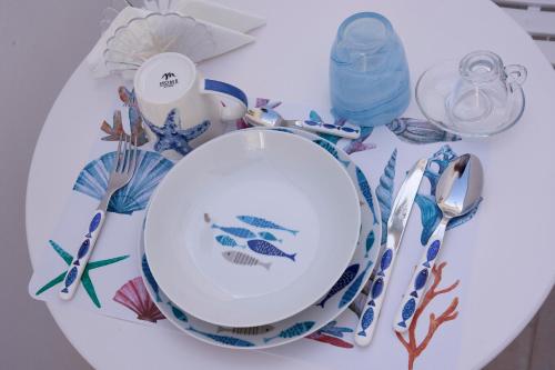 a table with a plate and utensils on it at il Truciolo Suite in Anacapri