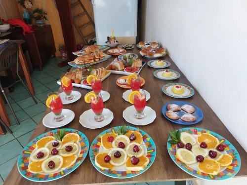 a long table with plates of food and drinks at B&B Alfrantoio Valderice in Valderice