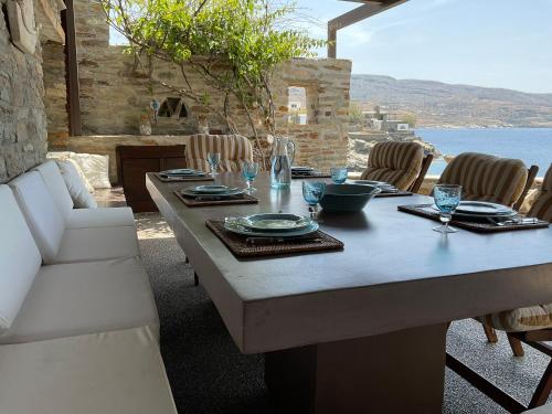 a table with plates and glasses on top of it at KeaSouth in Koundouros