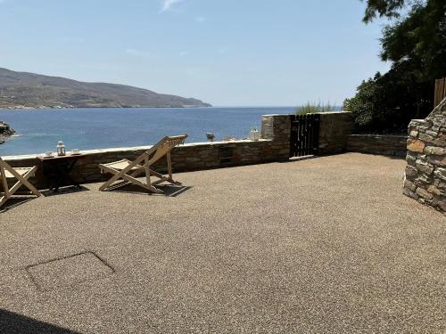 a patio with a table and a view of the water at KeaSouth in Koundouros