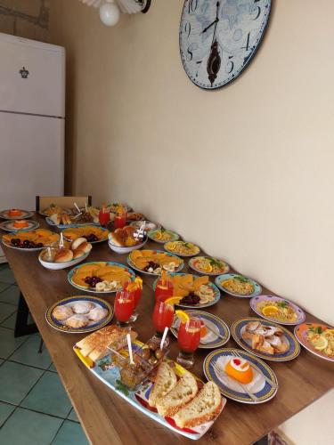 a long table with plates of food on it at B&B Alfrantoio Valderice in Valderice