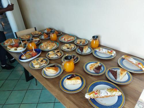 a long table with plates of food on it at B&B Alfrantoio Valderice in Valderice