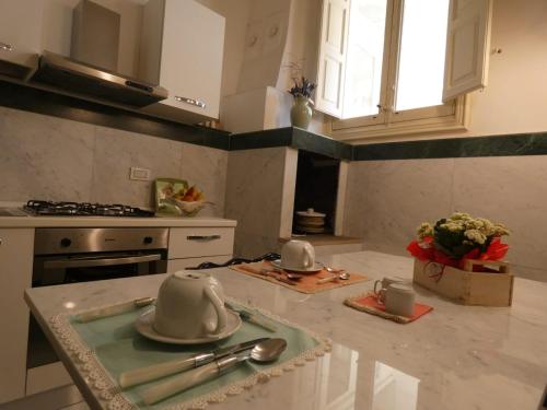 a kitchen with a counter with utensils on it at B&b RARO' LIBERTY in Lecce