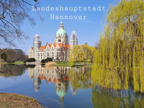 a building reflected in the water in front of a lake at Kansteinblick Weserbergland in Salzhemmendorf