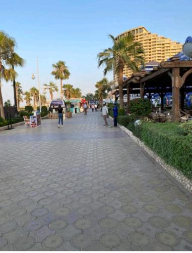 a cobblestone street with palm trees and a building at شاليه فاخر بالبانوراما بورتوسخنه للعائلات فقط porto sokhna chalets in Ain Sokhna