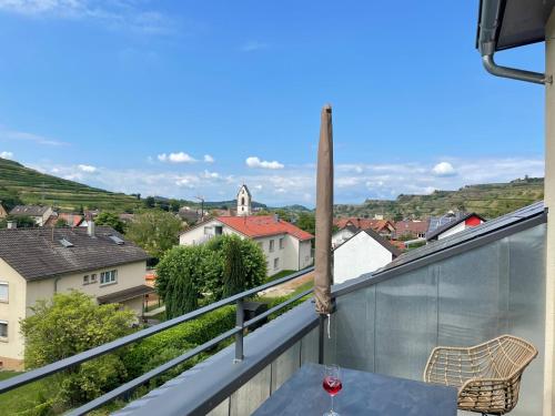 a balcony with a table and a view of a city at Weingut & Straußwirtschaft Vogel in Vogtsburg