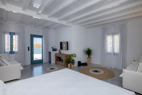 a white room with a bed and a living room at Royal-Ma Resort in Perástra