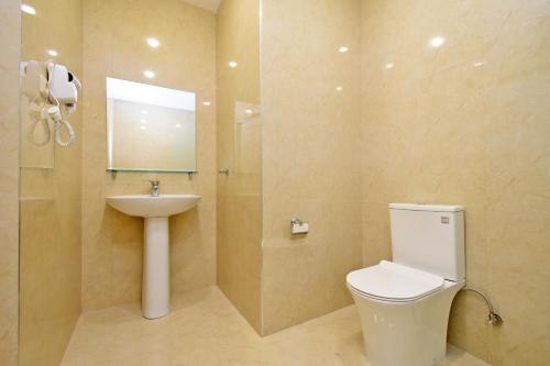 a bathroom with a toilet and a sink at Macao Hotel in Yerevan