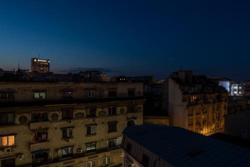 a view of a city skyline at night at Old Town Home Library in Bucharest