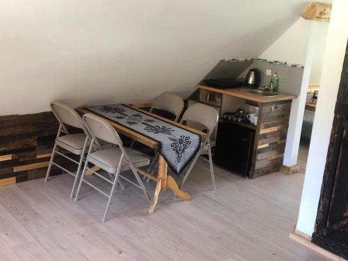 a dining room table with chairs and a desk at Rochowa Buznica in Zakopane