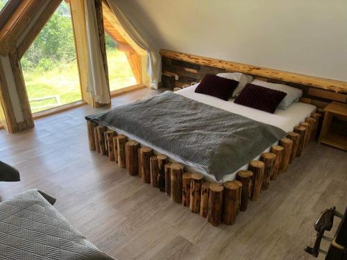 a bedroom with a bed made out of logs at Rochowa Buznica in Zakopane