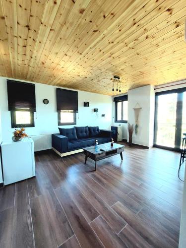 a living room with a couch and a table at Agros Green Valley Suites in Limassol