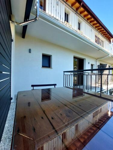 a wooden deck in a house with a balcony at Agros Green Valley Suites in Limassol