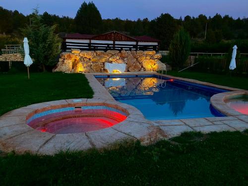 a swimming pool in a yard with a gazebo at El BURGO DE OSMA ALOJAMIENTO RURAL VILLA BAGH in El Burgo de Osma