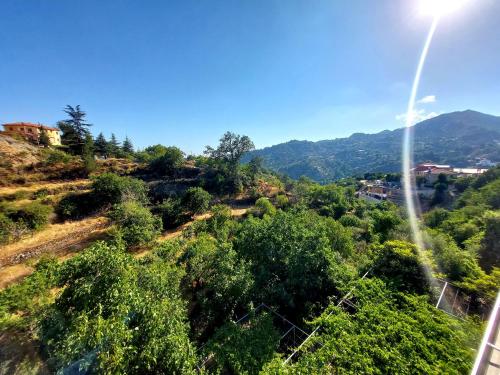a view of a hill with trees and mountains at Agros Green Valley Suites in Limassol
