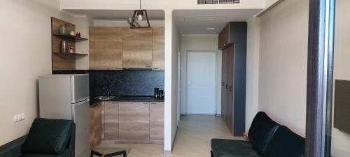 a small kitchen with a refrigerator and a counter at Via Tsaghkadzor in Tsaghkadzor