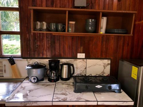 a kitchen with a stove and a counter top at Pizote house in Monteverde Costa Rica