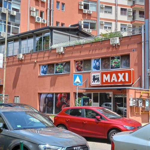 a red car parked in front of a building at Rivijera in Belgrade