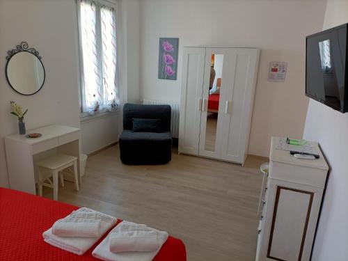 1 dormitorio con 1 cama, 1 silla y TV en Affittacamere Il Chiostrino Guest House, en Florencia
