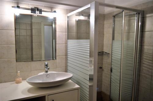 a bathroom with a sink and a shower at Elenos Villa in Possidi