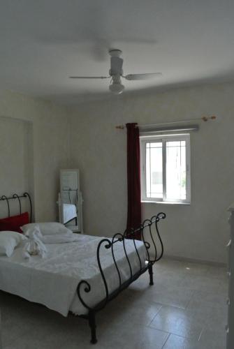 a bedroom with a bed and a window at central square HOUSE kokalaki in Kefalos