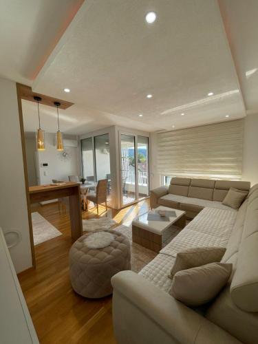 a living room with a couch and a table at Apartman Sisters in Sanski most