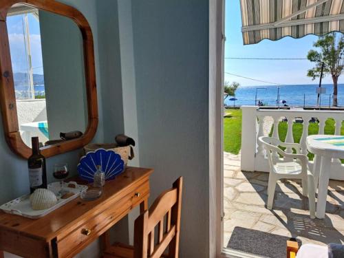 a mirror on a dresser in a room with a table at Dimitra's Family Apartments 2 in Paradisos