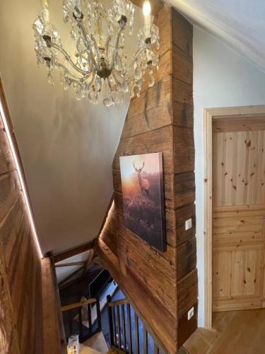 a chandelier hangs over a staircase in a house at Muggel Apartments in Alpirsbach