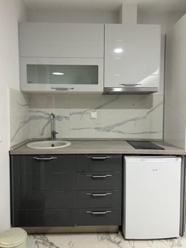 a bathroom with a sink and a counter top at Rani Apartments in Chrysi Ammoudia