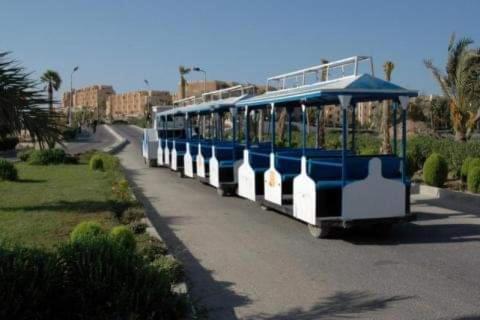 a blue and white trolley driving down a street at شاليه رائع مجدد للعائلات فقط باندلسيه مطروح in Marsa Matruh