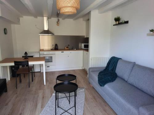 a living room with a couch and a table at Appartement RDC-Loire à vélo-Proche Saumur in Parnay