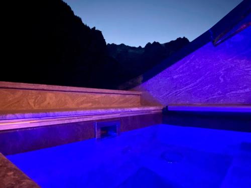 a bath tub with purple lights in a room at Gran Baita Hotel & Wellness in Courmayeur