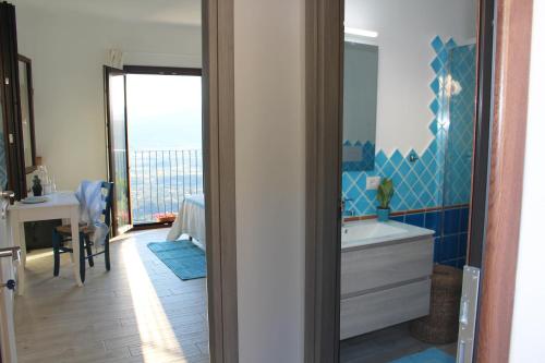 a bathroom with a tub and a sink and a mirror at Sa Domm'e Galleria in Baunei