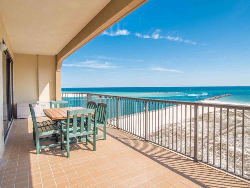 a balcony with a table and chairs and the beach at Grand Pointe #714 in Orange Beach