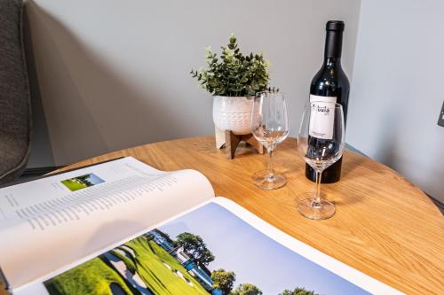 a bottle of wine and two glasses on a table at The Arran, St Andrews in St. Andrews