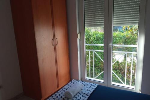 a bedroom with a bed and a large window at Apartment Sun in Klek