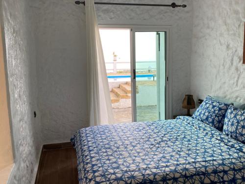 a bedroom with a bed with a view of the ocean at LES OLIVIERS Villa N1 avec piscine privée in Oualidia