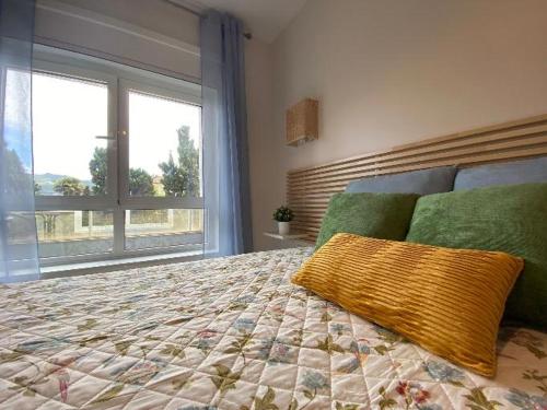 a bedroom with a large bed with a pillow on it at Samil primera línea de playa in Vigo