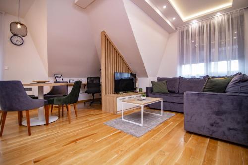 a living room with a couch and a table at Titova Vila Zlatibor in Zlatibor
