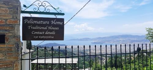 a sign for a restaurant with a view of the water at Pelionature Maizonette in Makrinítsa
