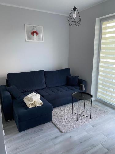 a living room with a blue couch and a table at Apartment Comfort in Bartoszyce