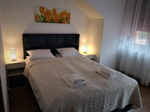 a bedroom with a large bed with towels on it at Villa MISTRAL przy plaży in Sława