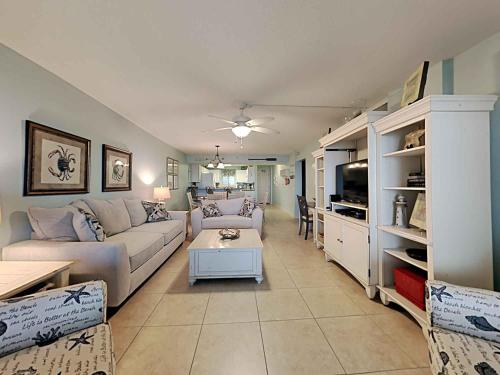a living room with a couch and a table at Sandy Key #323 in Perdido Key