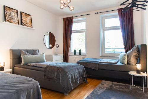 a bedroom with two beds and a window at Kaßberg - Studio mit Balkon, Netlfix und Wifi in Chemnitz